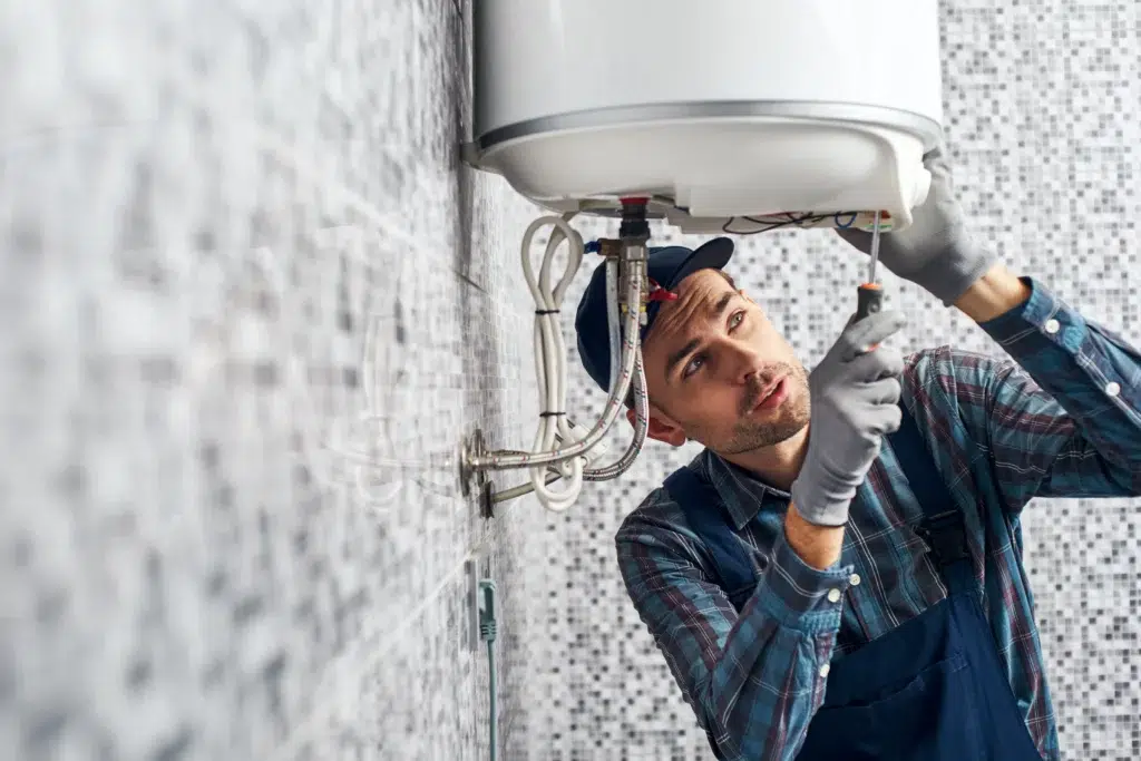 Technician repairing water heater in Sacramento, CA.