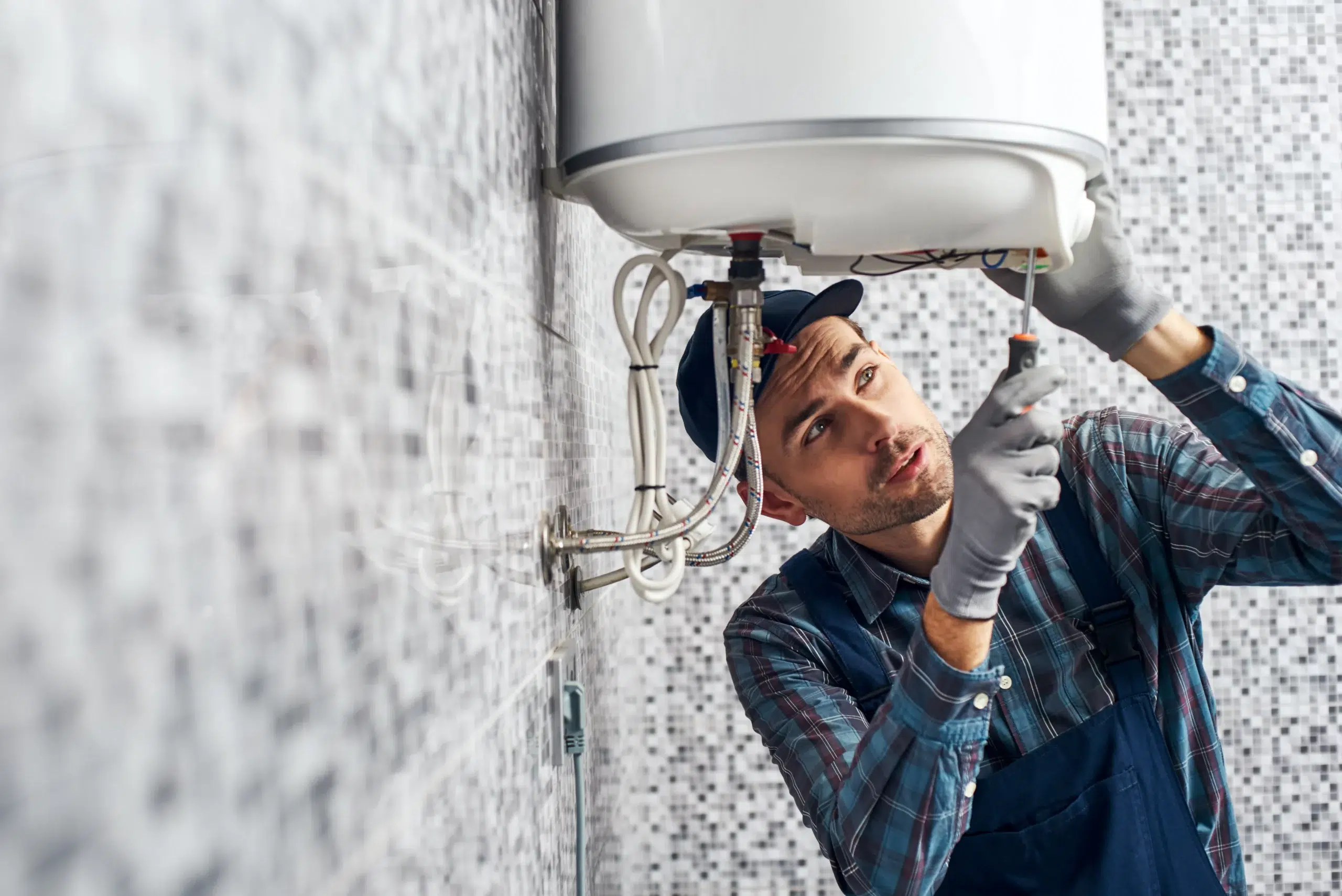 Technician repairing water heater in Sacramento, CA.