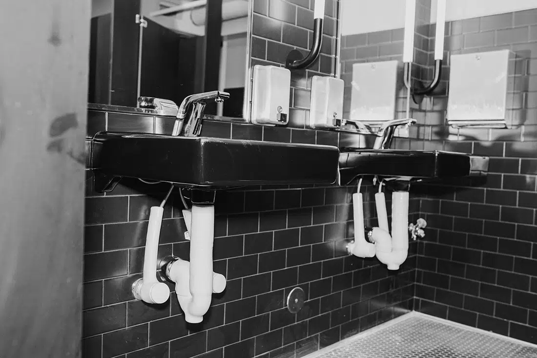 Bathroom plumbing in commercial bathroom in Sacramento, CA.