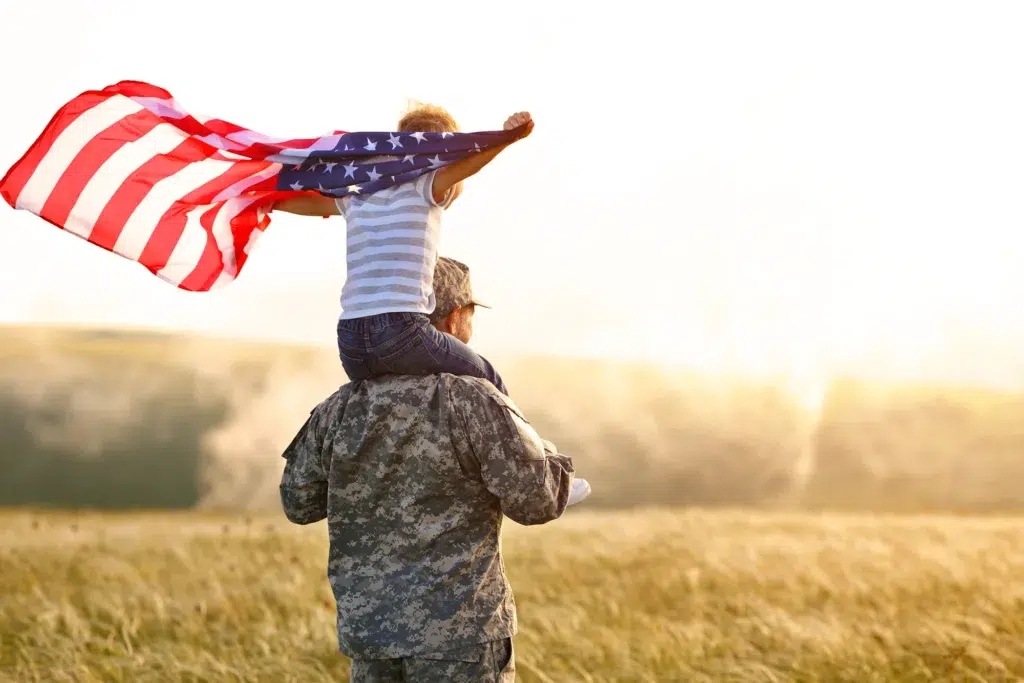 veteran with child with american flag